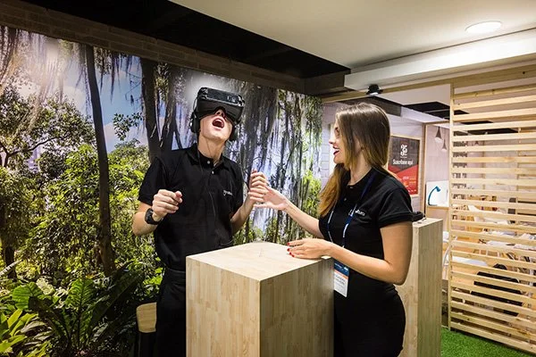 A guest trying a virtual reality experience with an event host